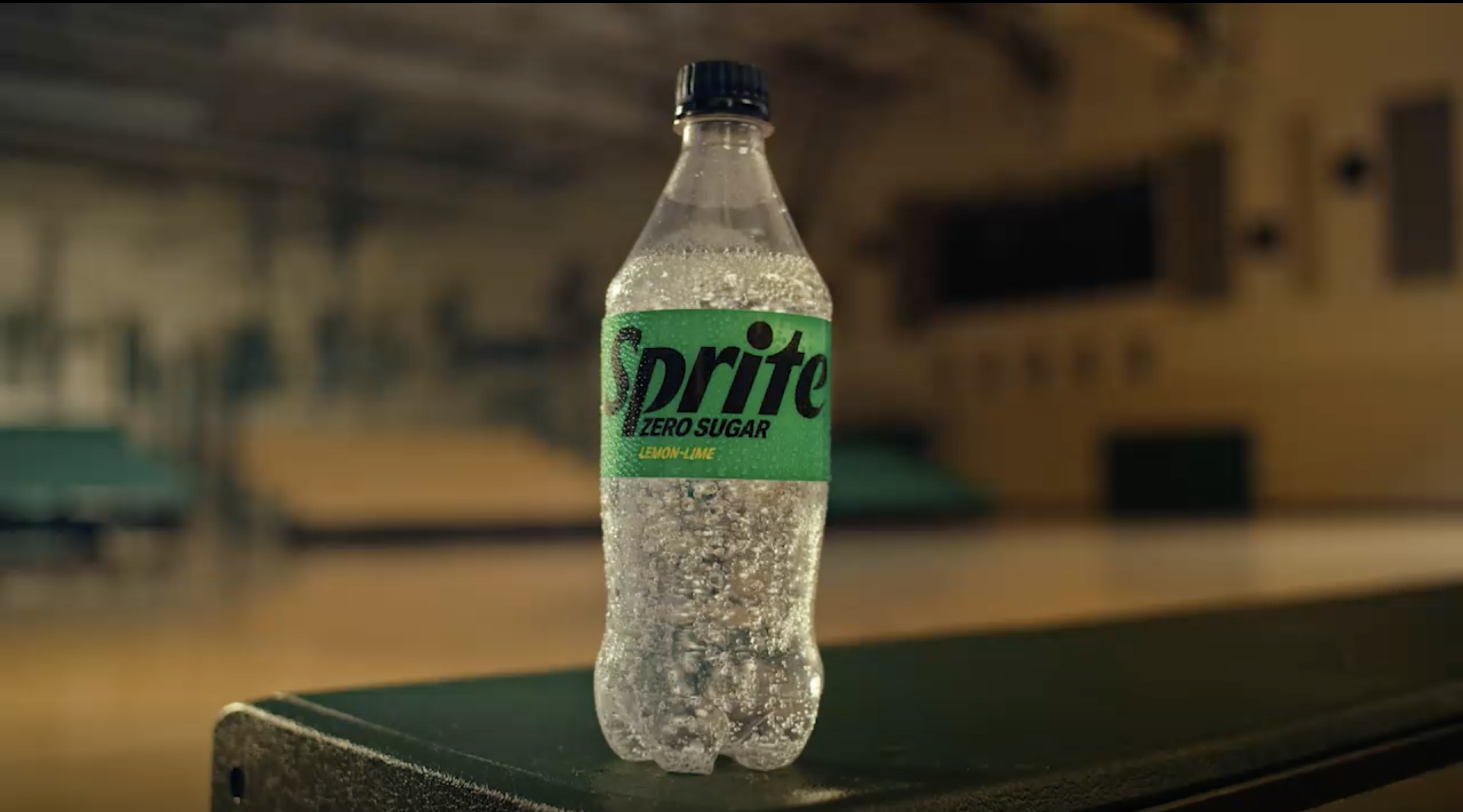 Bottle of sprite by a basketball court
