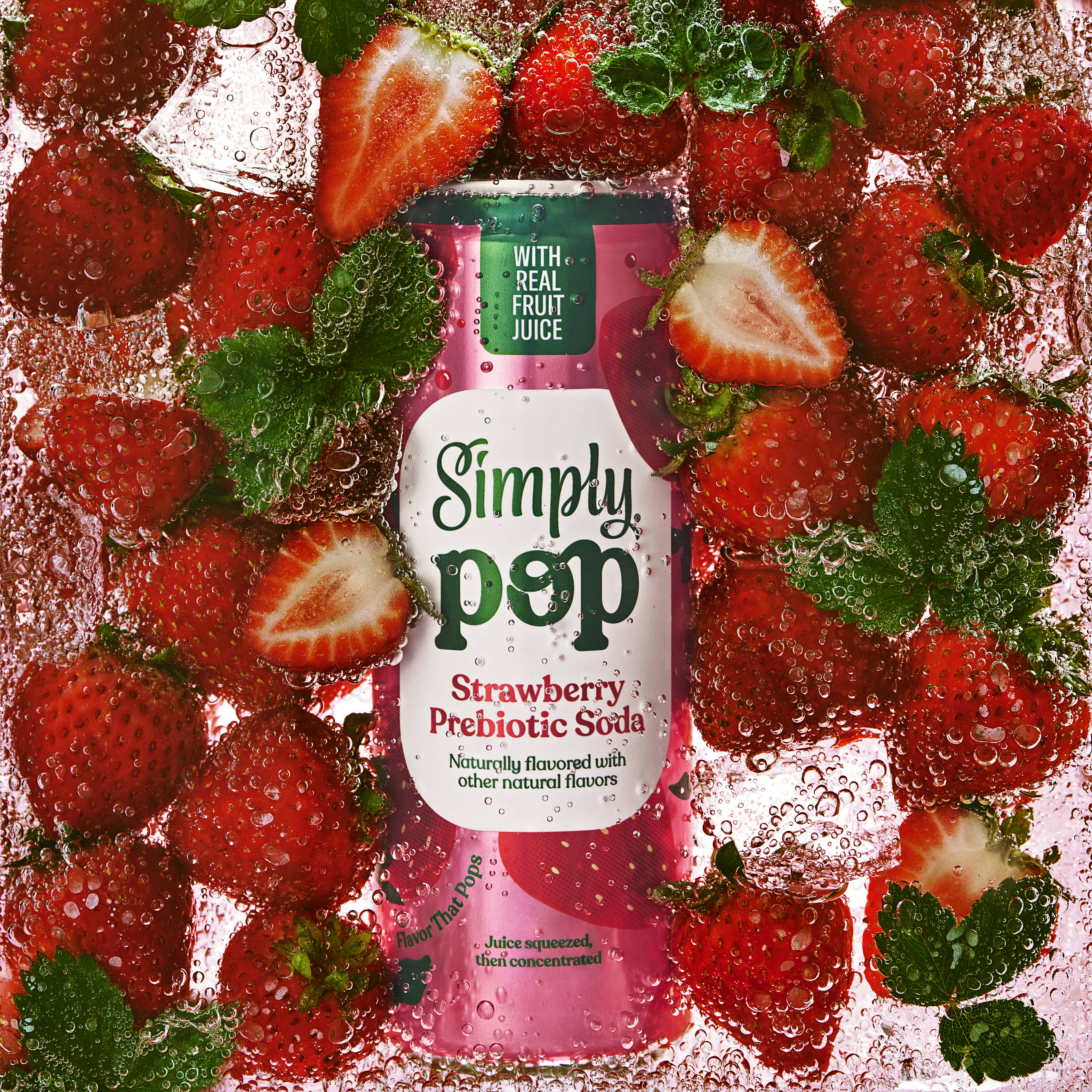 Simply Pop strawberry flavor can floating in soda with strawberries